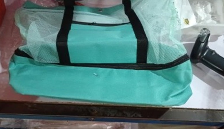 Close-up of mint green insulated cooler bottom compartment fabric